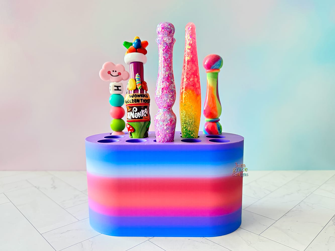 Colorful crochet hook stand with various colorful crochet hooks against a gradient background