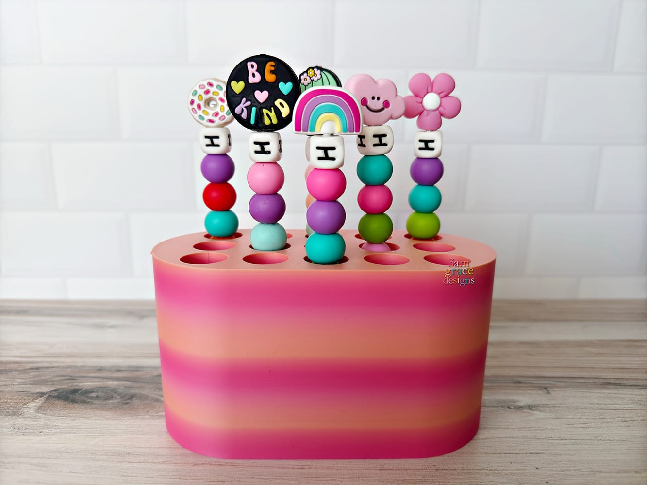 Colorful crochet hook stand with beaded crochet hooks on a wooden surface
