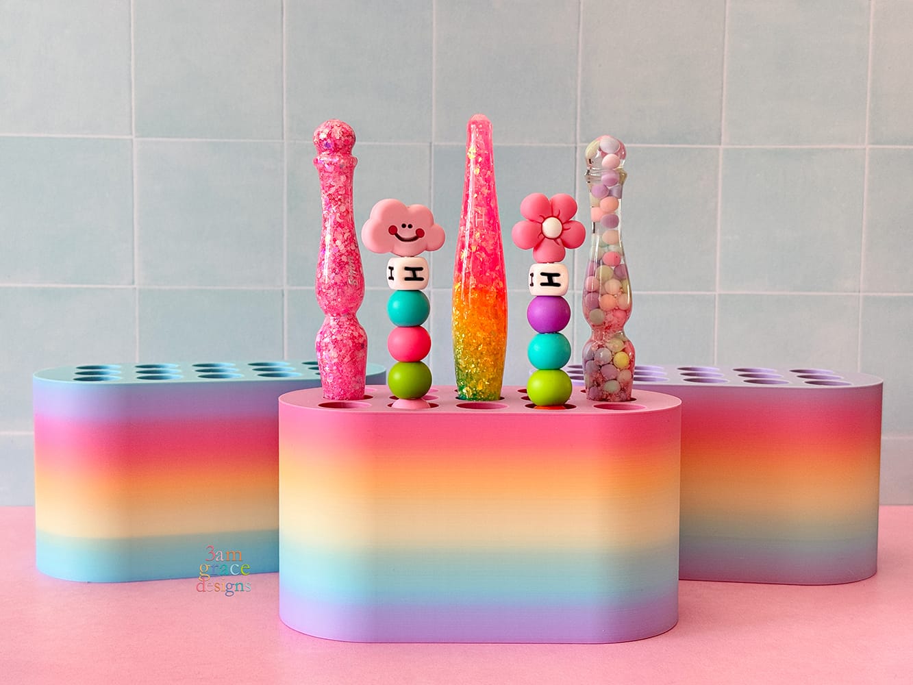 Colorful crochet hook holder with various crochet hooks on a tiled wall background