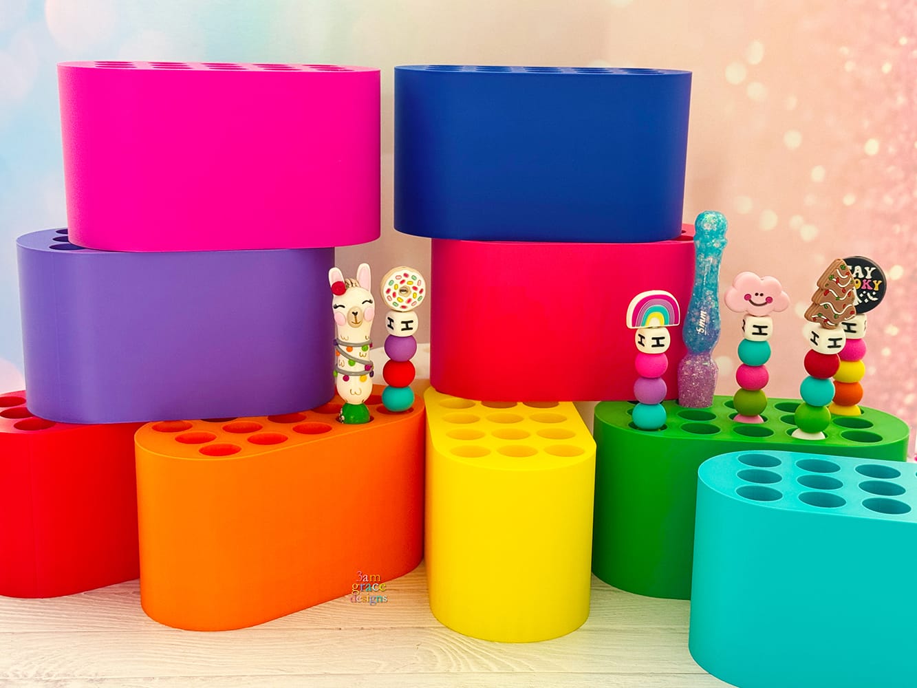 Colorful crochet hook stands with crochet hooks on a light wooden surface.