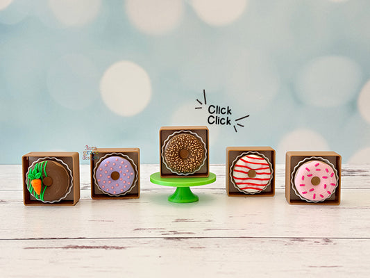 Decorative donut boxes fidget clickers on a wooden surface and light blue background
