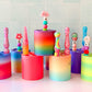 Colorful gradient crochet hook holders. Holder can hold 7 hooks. Pictued with crochet hooks on a tiled wall background.