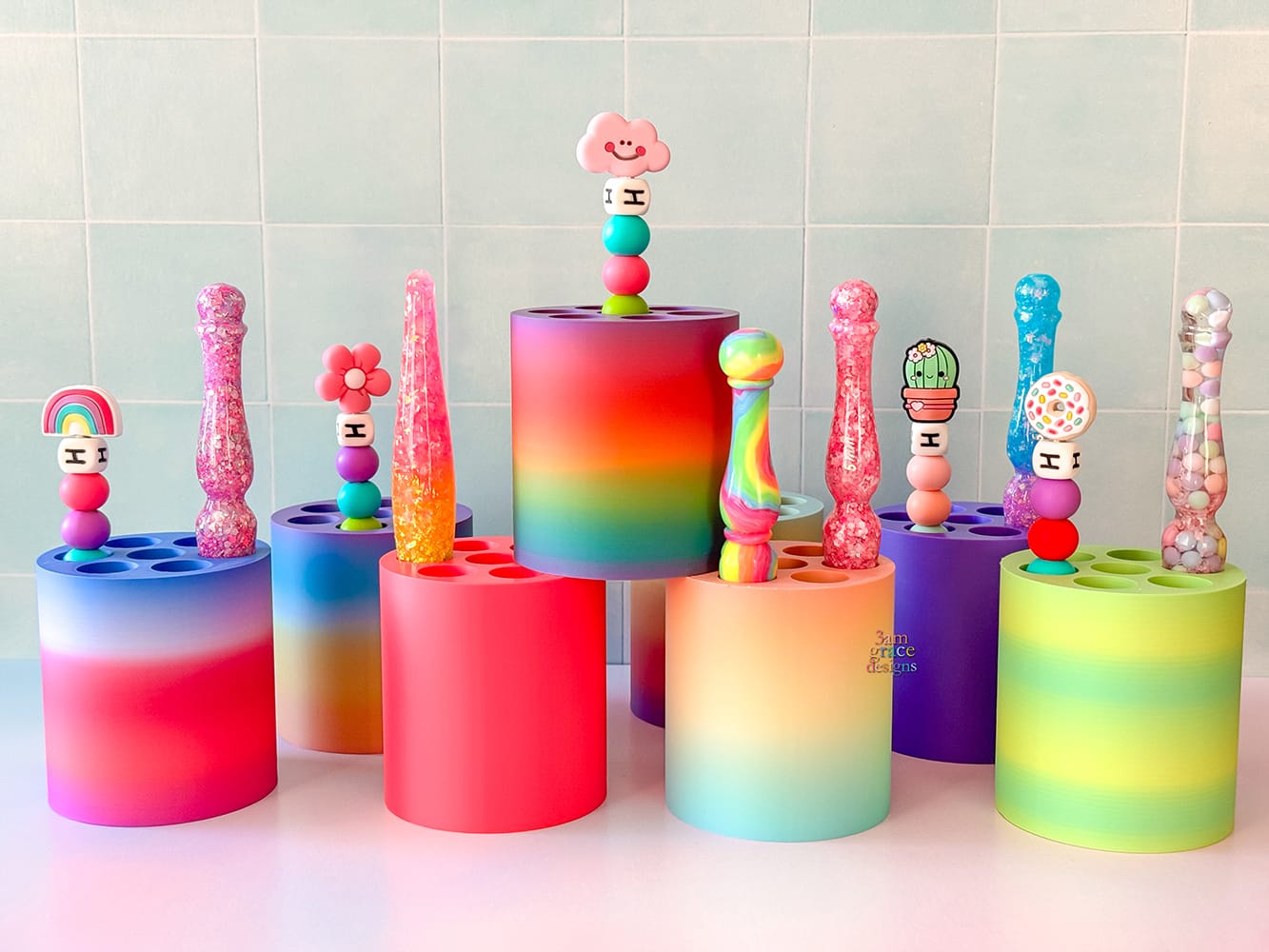 Colorful gradient crochet hook holders. Holder can hold 7 hooks. Pictued with crochet hooks on a tiled wall background.