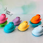 Colorful Chick Peep fidget clickers on a white background.
