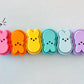 Colorful peep-shaped fidget clickers on a white background 