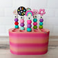 Colorful crochet hook stand with beaded crochet hooks on a wooden surface