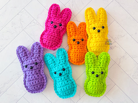 Kawaii amigurumi ragdoll style crochet pattern for a colorful crochet peep toys on a white tiled floor