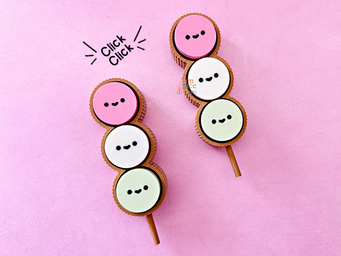 Dango fidget clicker with smiling faces on a pink background
