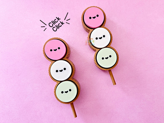 Dango fidget clicker with smiling faces on a pink background