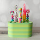 colorful crochet hooks on a green crochet hook stand against a plain background