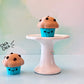 kawaii muffins fidget clicker on a white pedestal with bokeh background