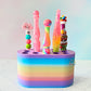 Colorful crochet hook stand with various colorful crochet hooks on a white floor and light blue wall background
