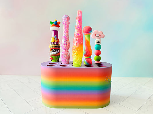 rainbow colored crochet hook stand with colorful crochet hooks on a blue background